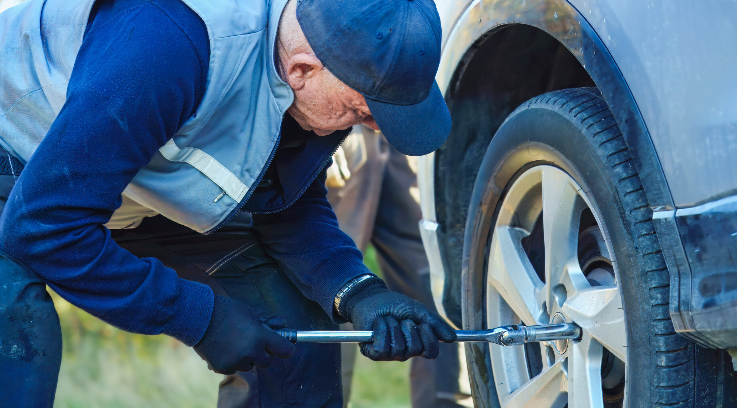 Mechanic replacing a car tire.