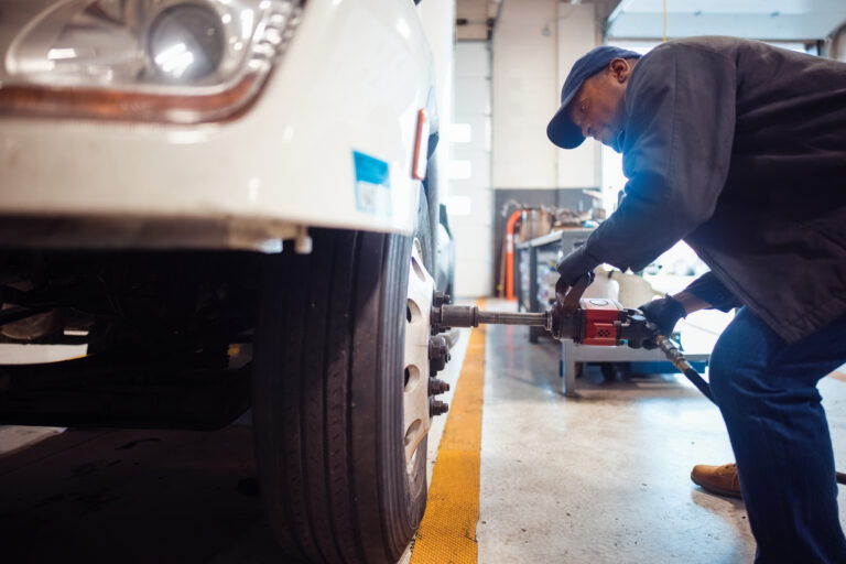 Technician Performing Maintenance on Truck in Repair Workshop